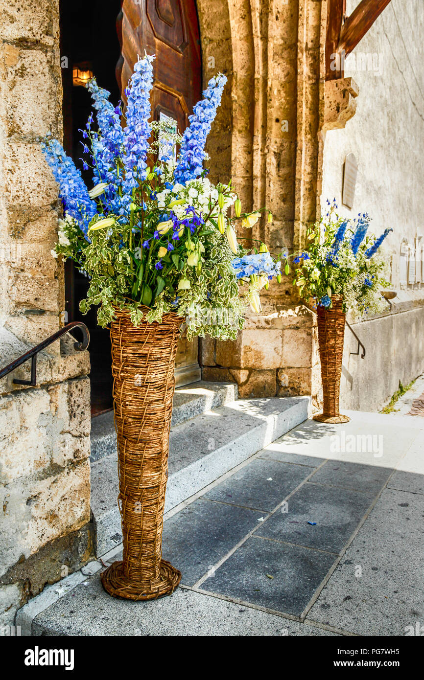 Flowers at the entrance into the church of Andrew the Apostle (Heiliger Andreas) in Kitzbuhl, Austria Stock Photo