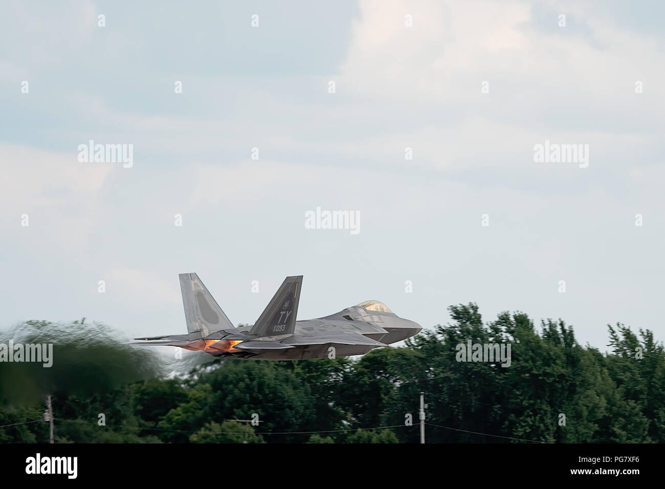 Oshkosh, WI - 28 July 2018:  A F-22 from the United States Air Force takes off with full afterburners Stock Photo