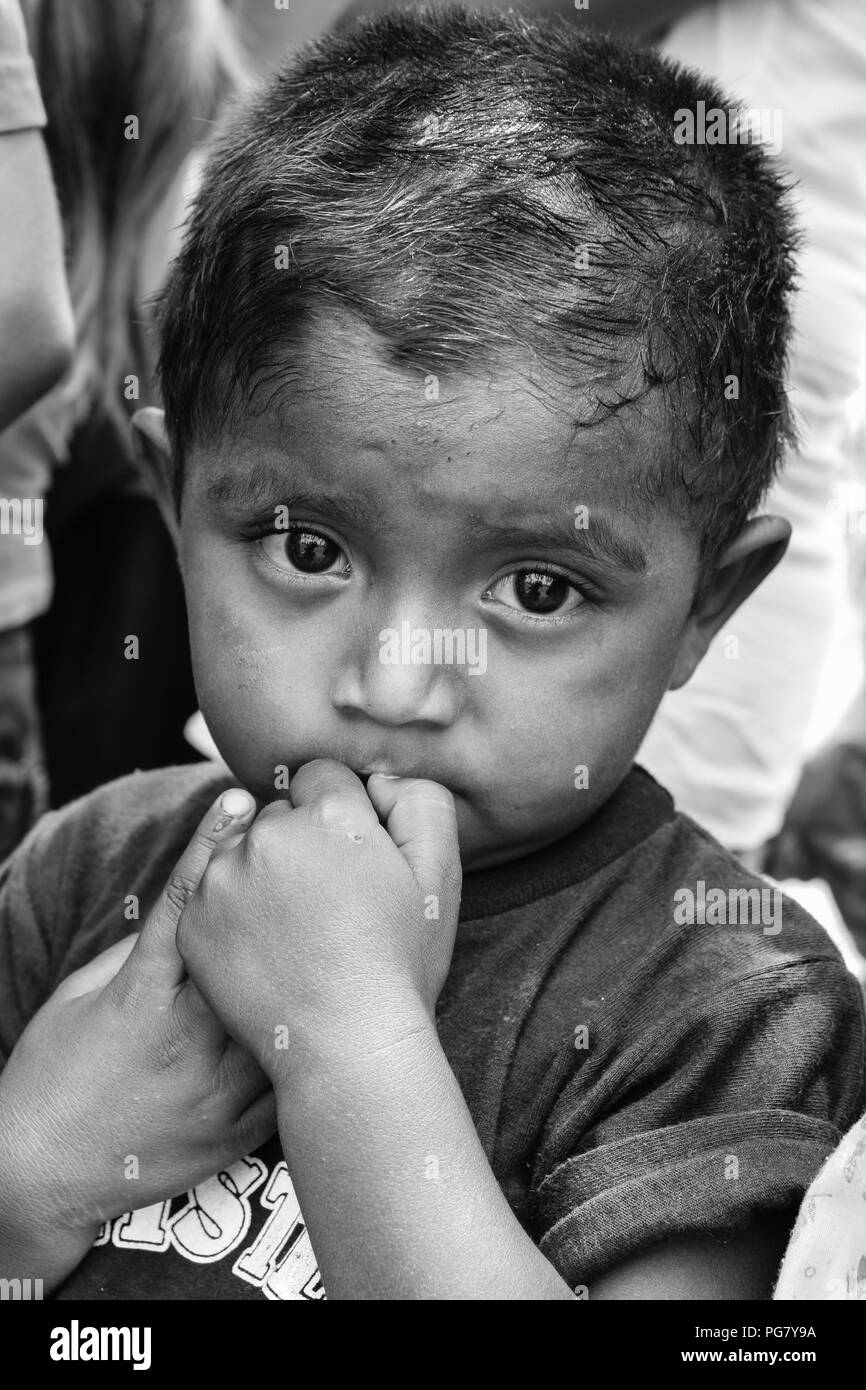 Managua, Nicaragua: A young boy waiting for food to be distributed by American missionaries in Central America. Stock Photo