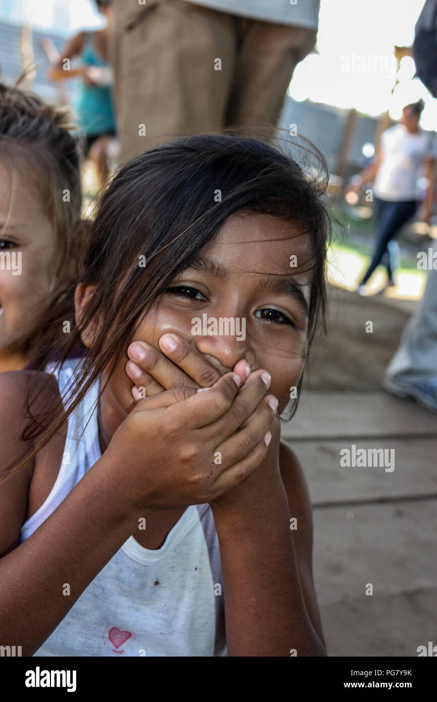 A young girl plays while waiting for food to be distributed by American missionaries in Central America. Stock Photo
