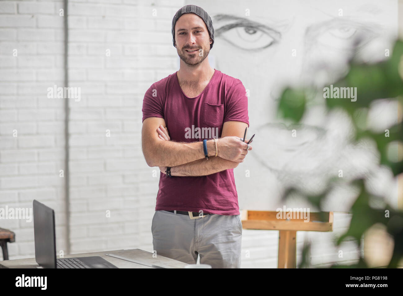 Portrait of confident artist with drawing in studio Stock Photo