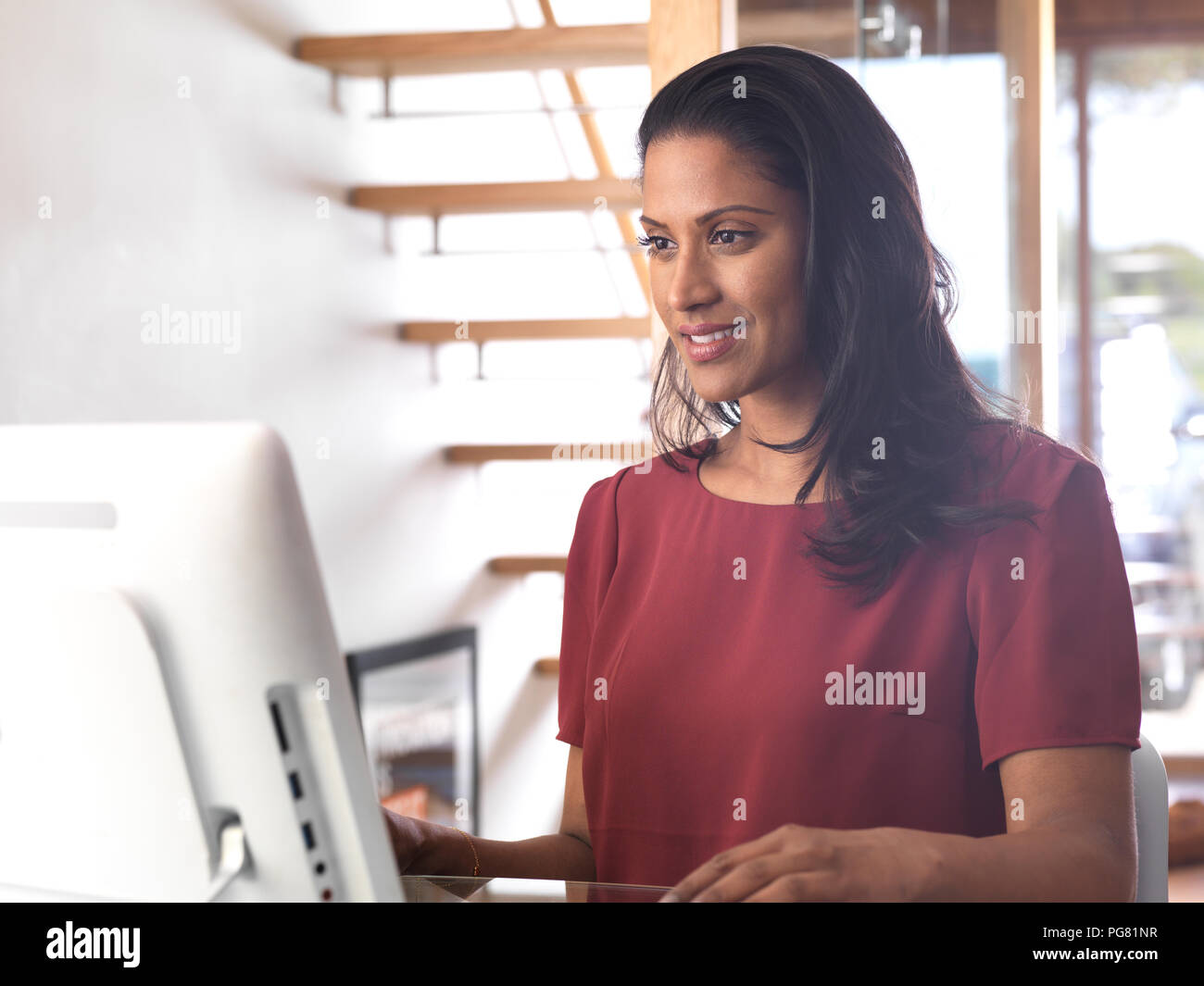 Portrait of smiling businesswoman using computer in office Stock Photo ...