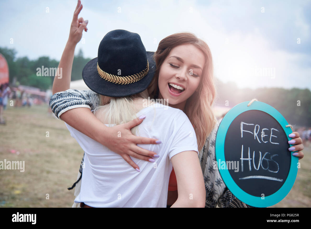 Young women embracing during at the music festival Stock Photo