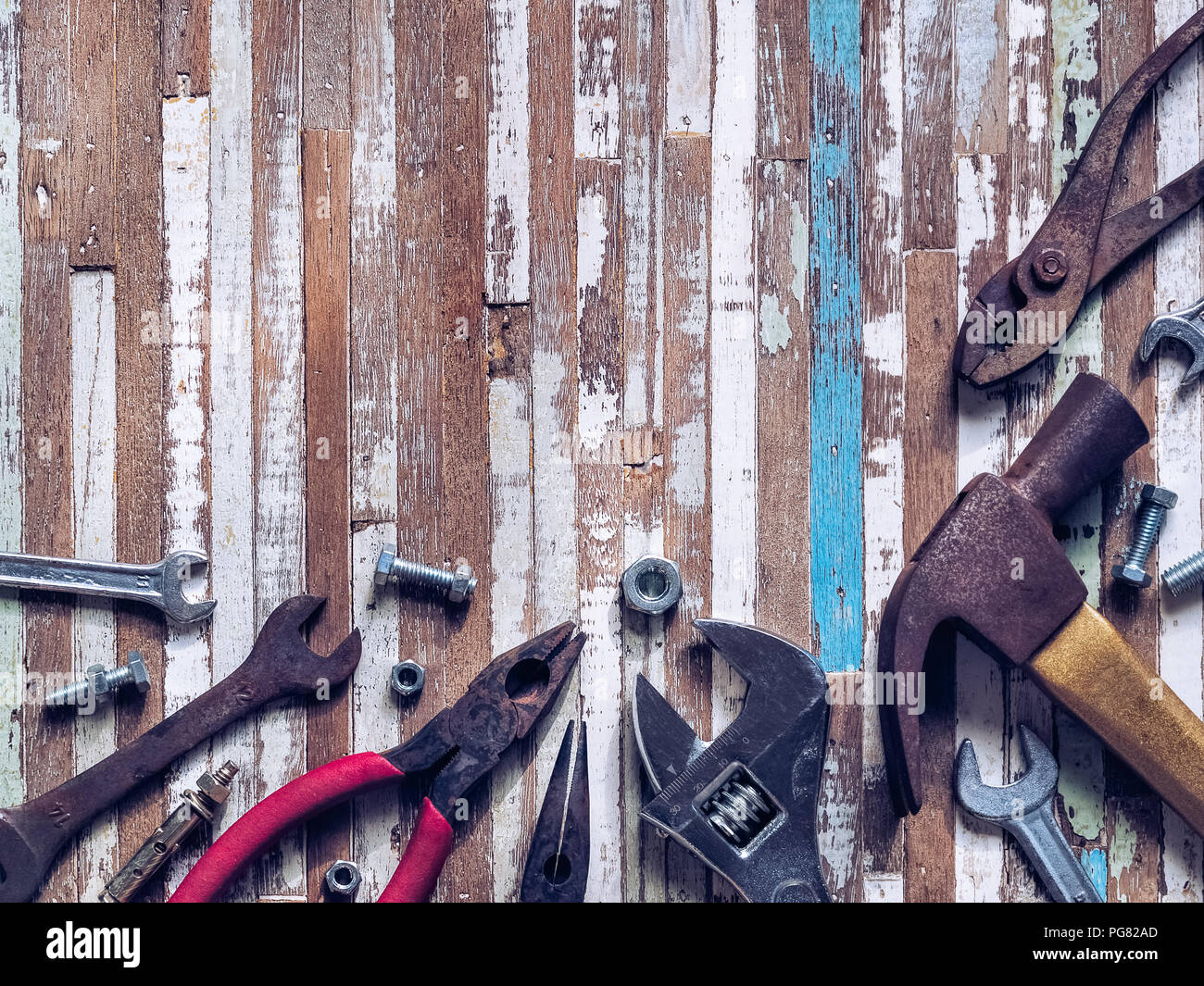 Variety rusty handy tools on grunge wooden background.  Labor day concept with blank copy space. Stock Photo