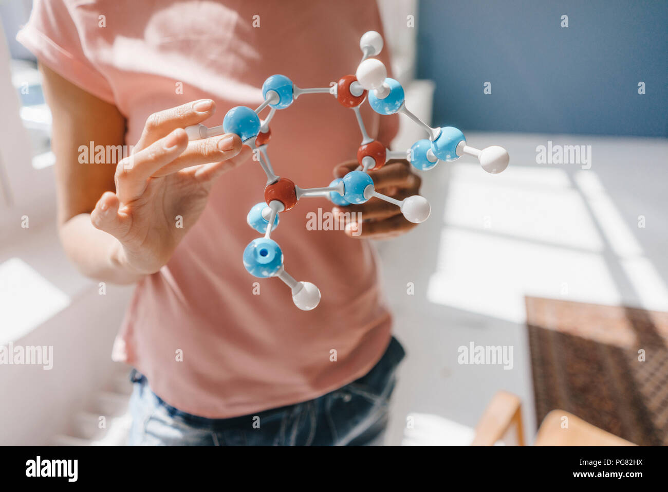 Female scientist holding molecule model Stock Photo