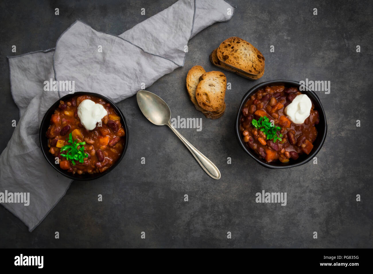 Two bowls of Chili con Carne with fresh coriander and sour cream Stock