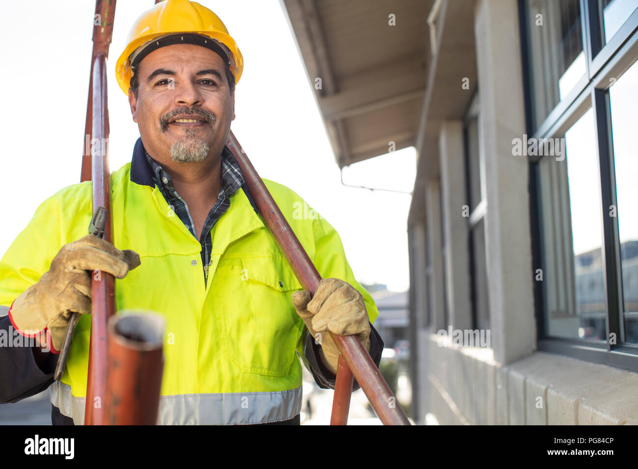 South Africa, Cape Town, Builder holding pipes Stock Photo Alamy