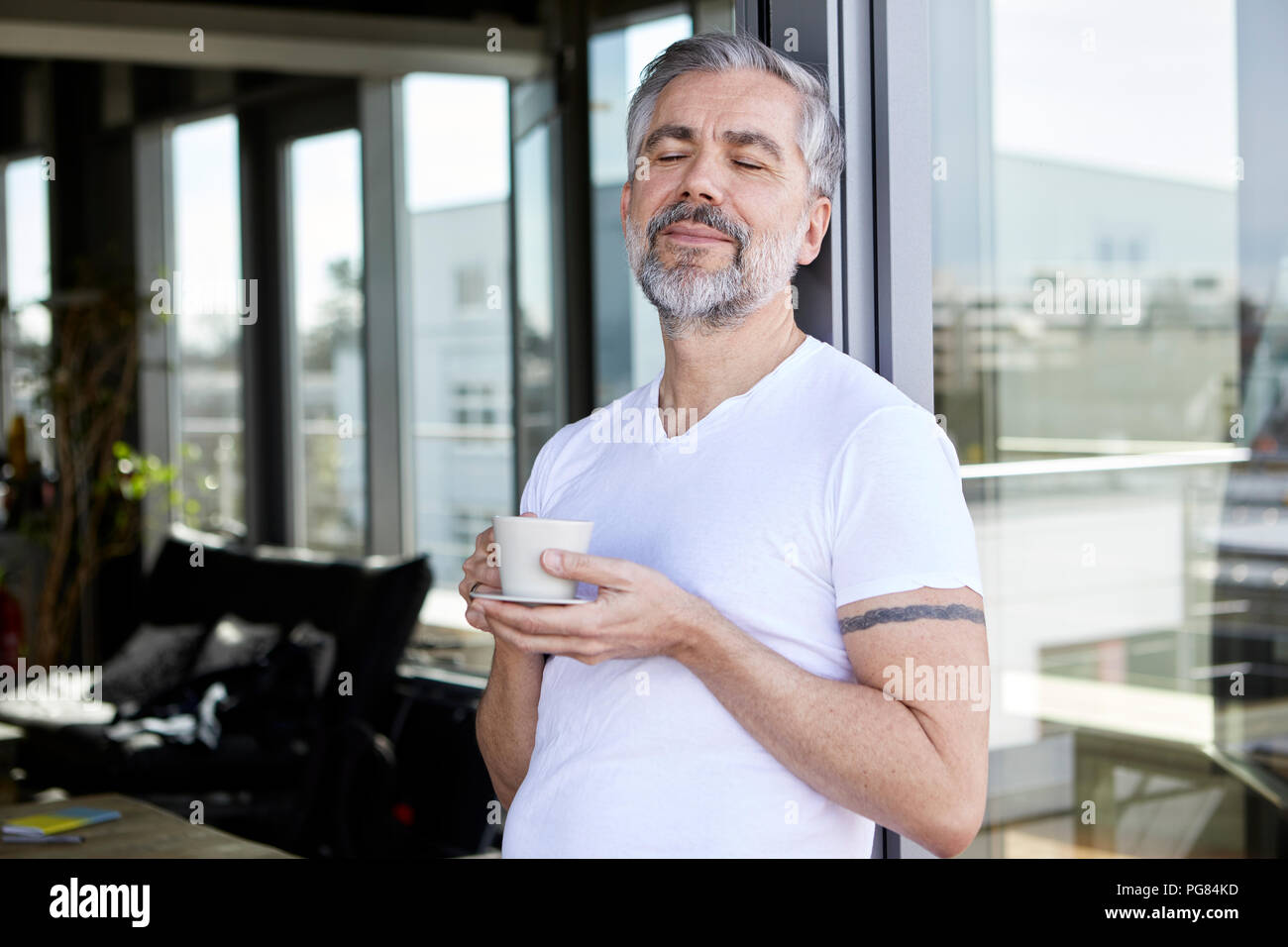 Man standing at French enjoying cup of coffee Stock Photo