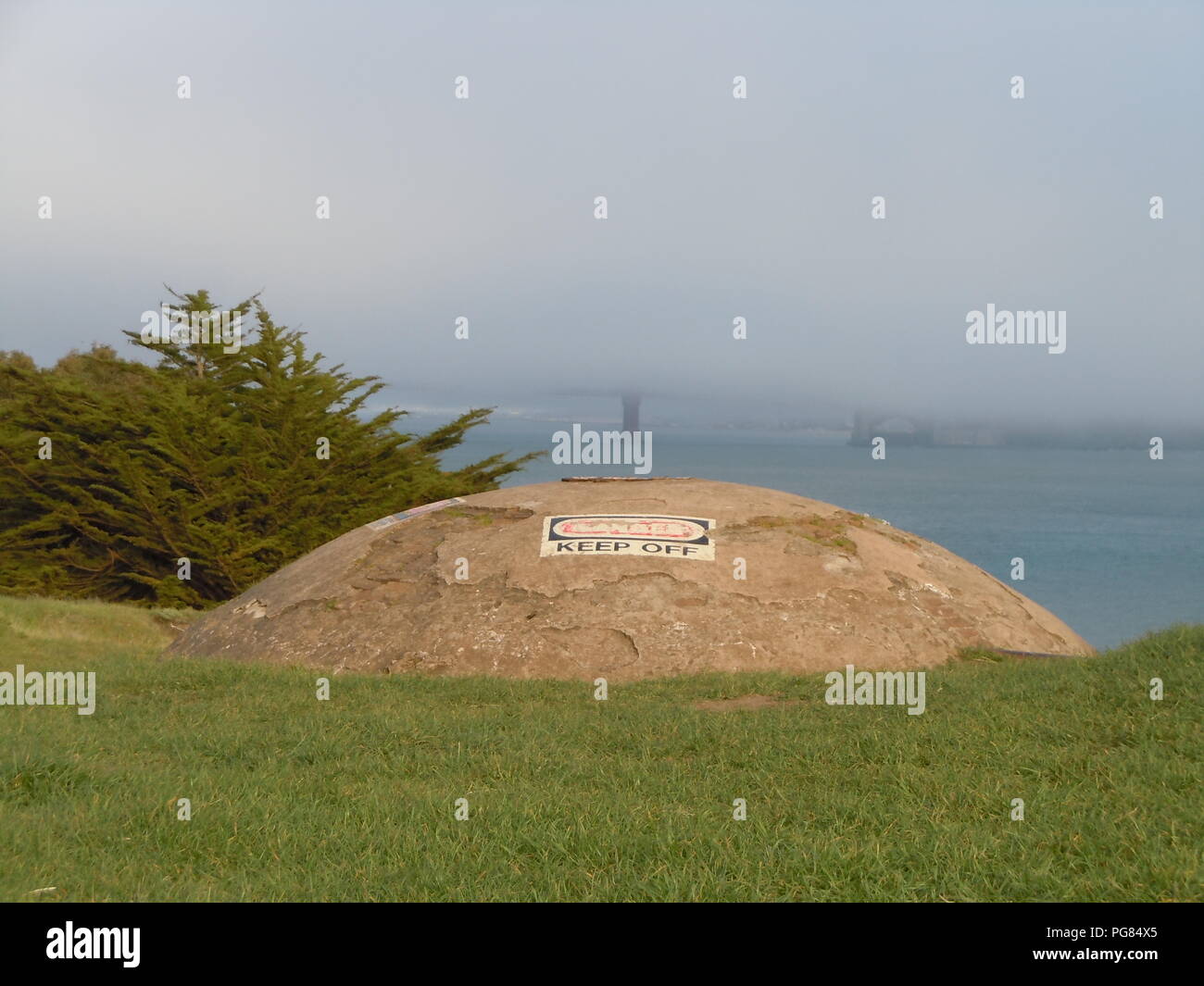 A view of the Golden Gate Bridge as seen from Hawk Hill in the Marin Headlands. Military bunkers can be seen in the foreground. Stock Photo