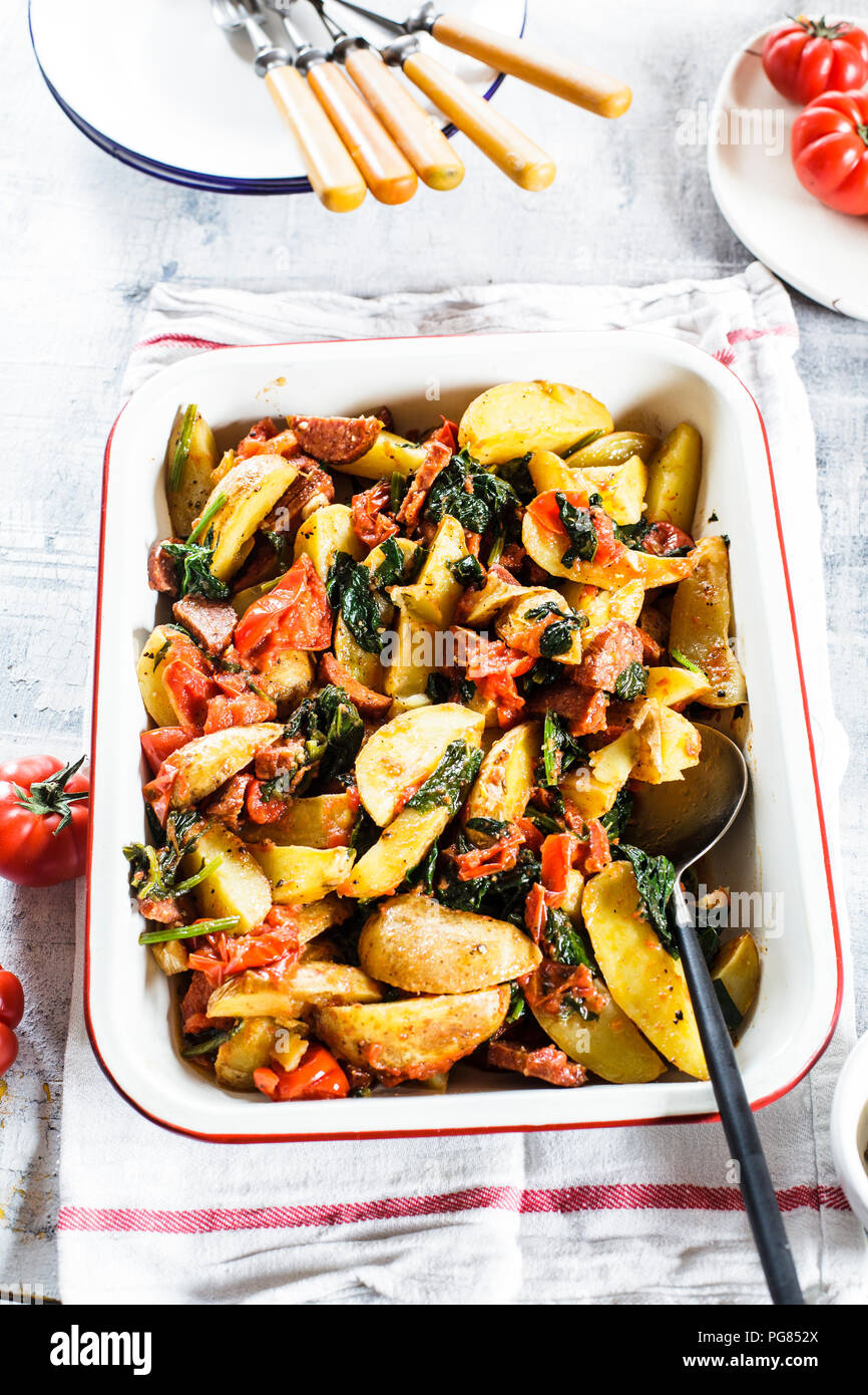 Casserole with potatoes, spinach, tomatoes and chorizzo Stock Photo