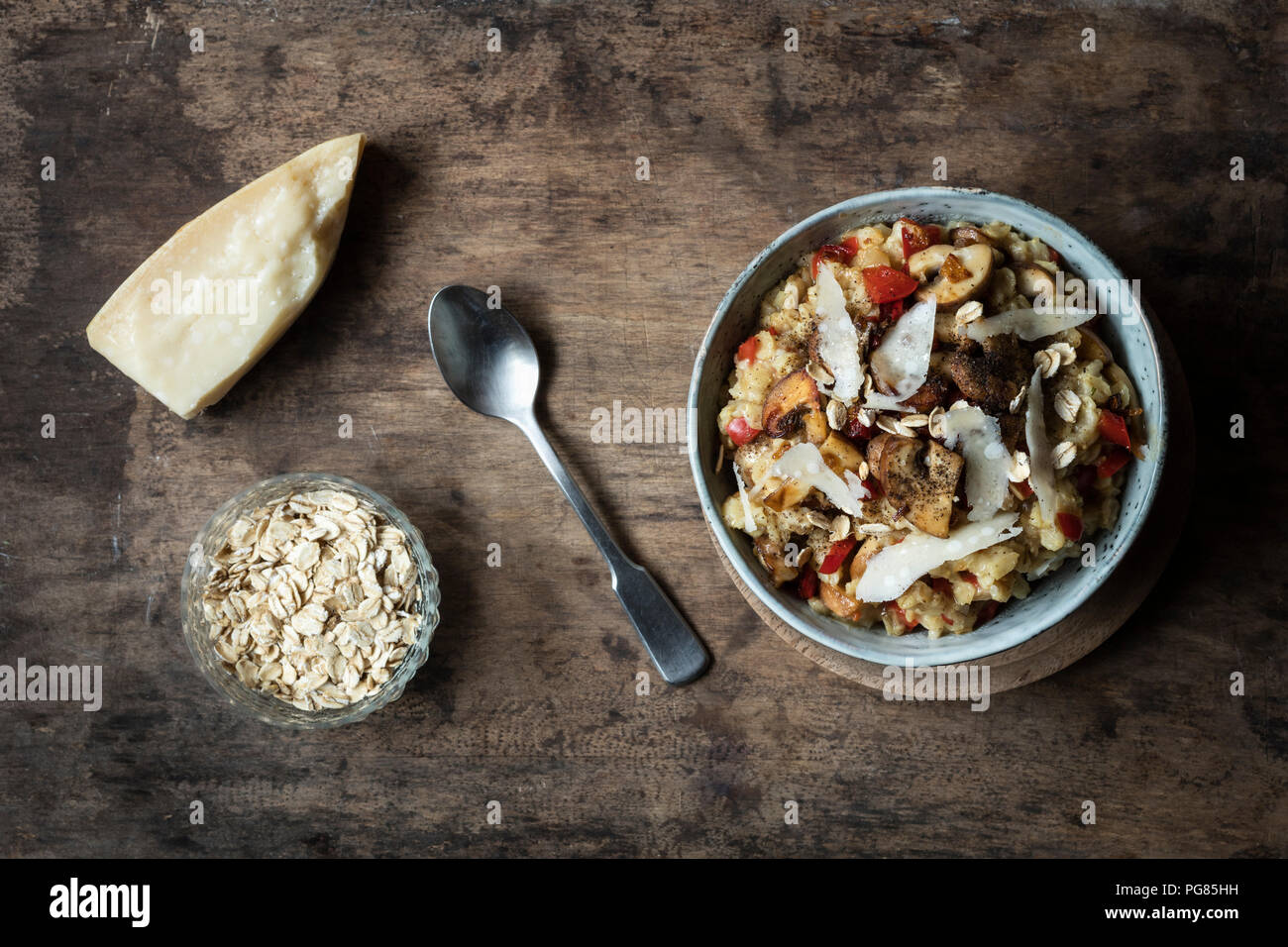 Bowl of porridge with bell pepper, champignon and parmesan Stock Photo