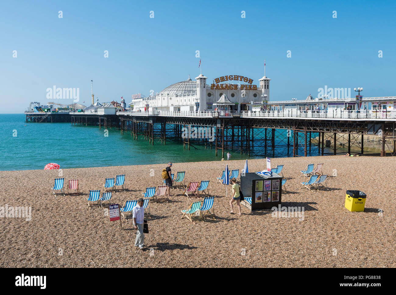 Brighton Palace Pier, a British seaside pier and shingle beach in Summer in Brighton, East Sussex, England, UK. Brighton pier blue sky. Stock Photo