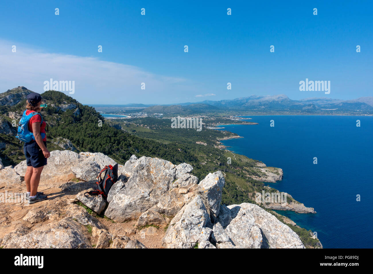 Woman contemplating the Alcudia bay from Penya Roja peak.Alcudia.Mallorca Island.Spain Stock Photo