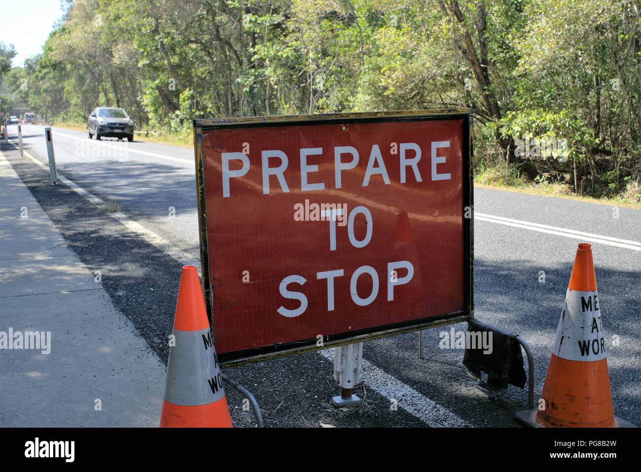 'Prepare to stop' on road sign board in Australia. Caution for drivers sign for traffic changes on Australian city street. Stock Photo