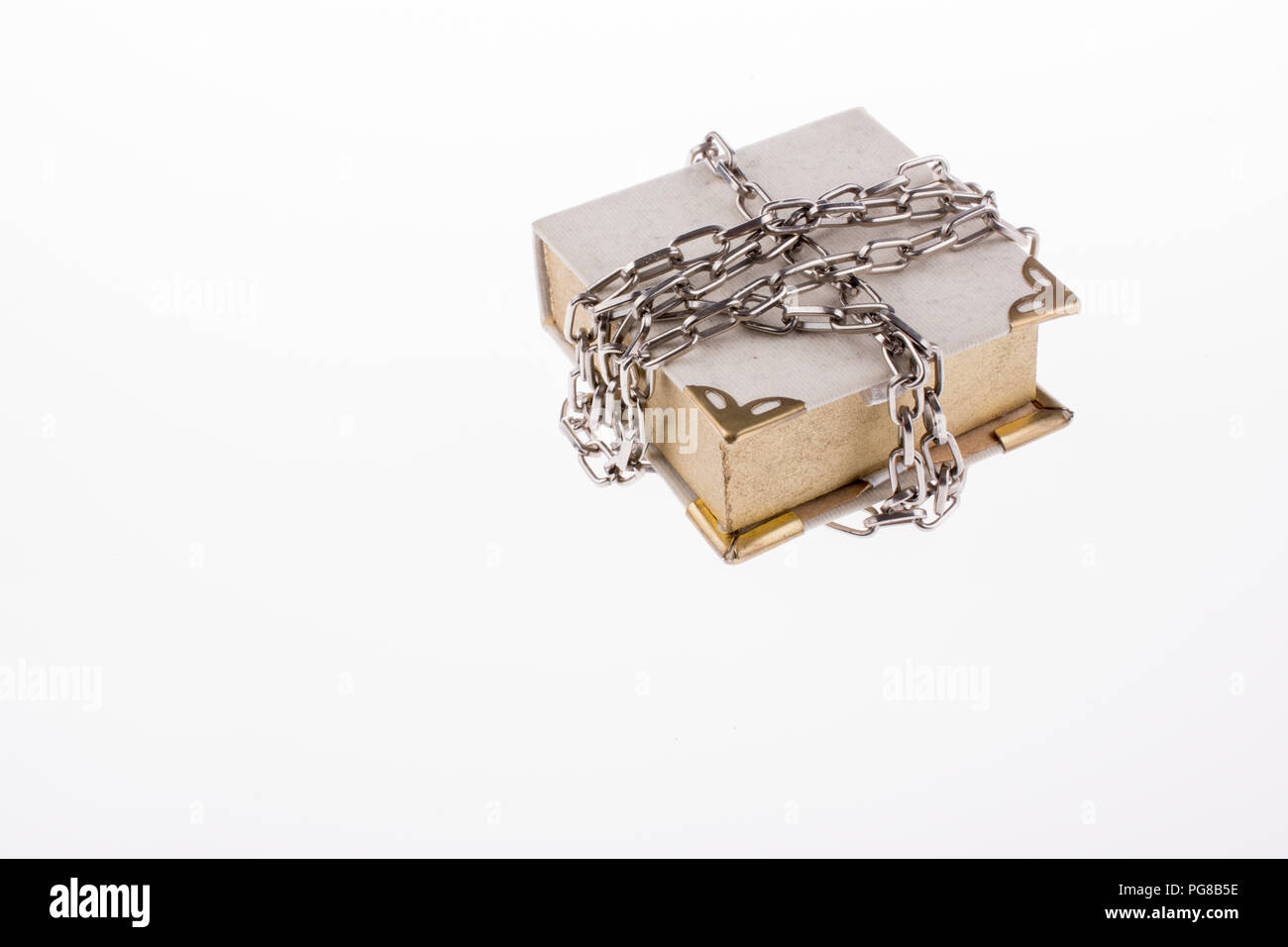 Chained book on white background Stock Photo