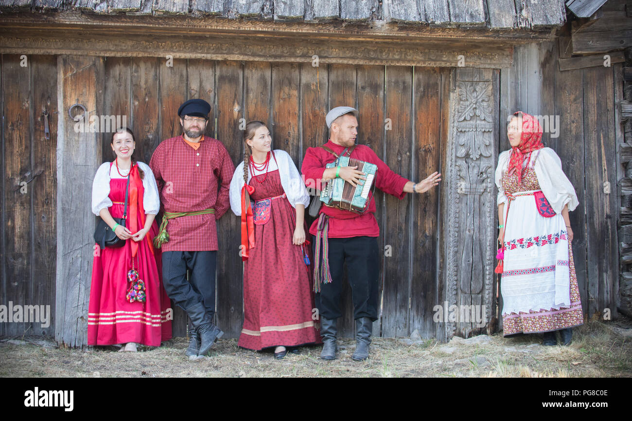 A group of people in national costumes stand in a row and pose for the ...