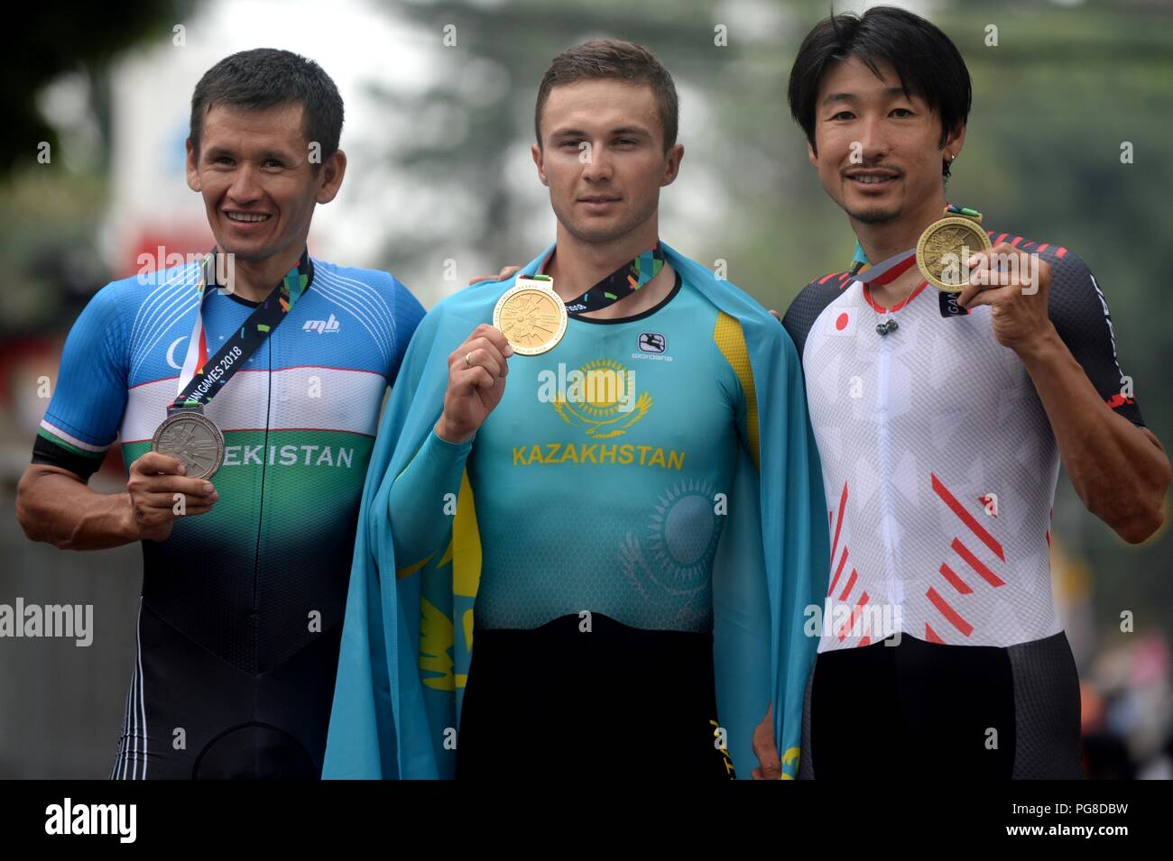 Subang, Indonesia. 24th Aug, 2018. Gold medalist Alexey Lutsenko (C) of Kazakhstan, Muradjan Khalmuratov (L) of Uzbekistan and Beppu Fumiyuki of Japan pose for photos during the awarding ceremony of the men's 40km individual time trial of cycling road event at the 18th Asian Games in Subang, West Java, Indonesia, Aug. 24, 2018. Credit: Agung Kuncahya B./Xinhua/Alamy Live News Stock Photo