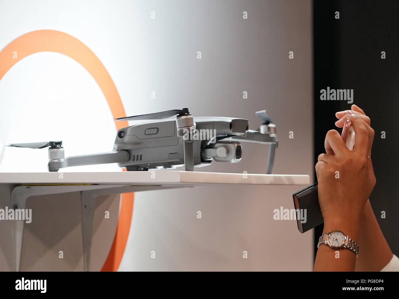 Beijing, China. 24th Aug, 2018. A visitor takes photos of the newly-released DJI Mavic 2 Pro drone during a launching event in Beijing, capital of China, Aug. 24, 2018. Chinese drone manufacturer DJI released its new Mavic drone Friday. Credit: Xing Guangli/Xinhua/Alamy Live News Stock Photo