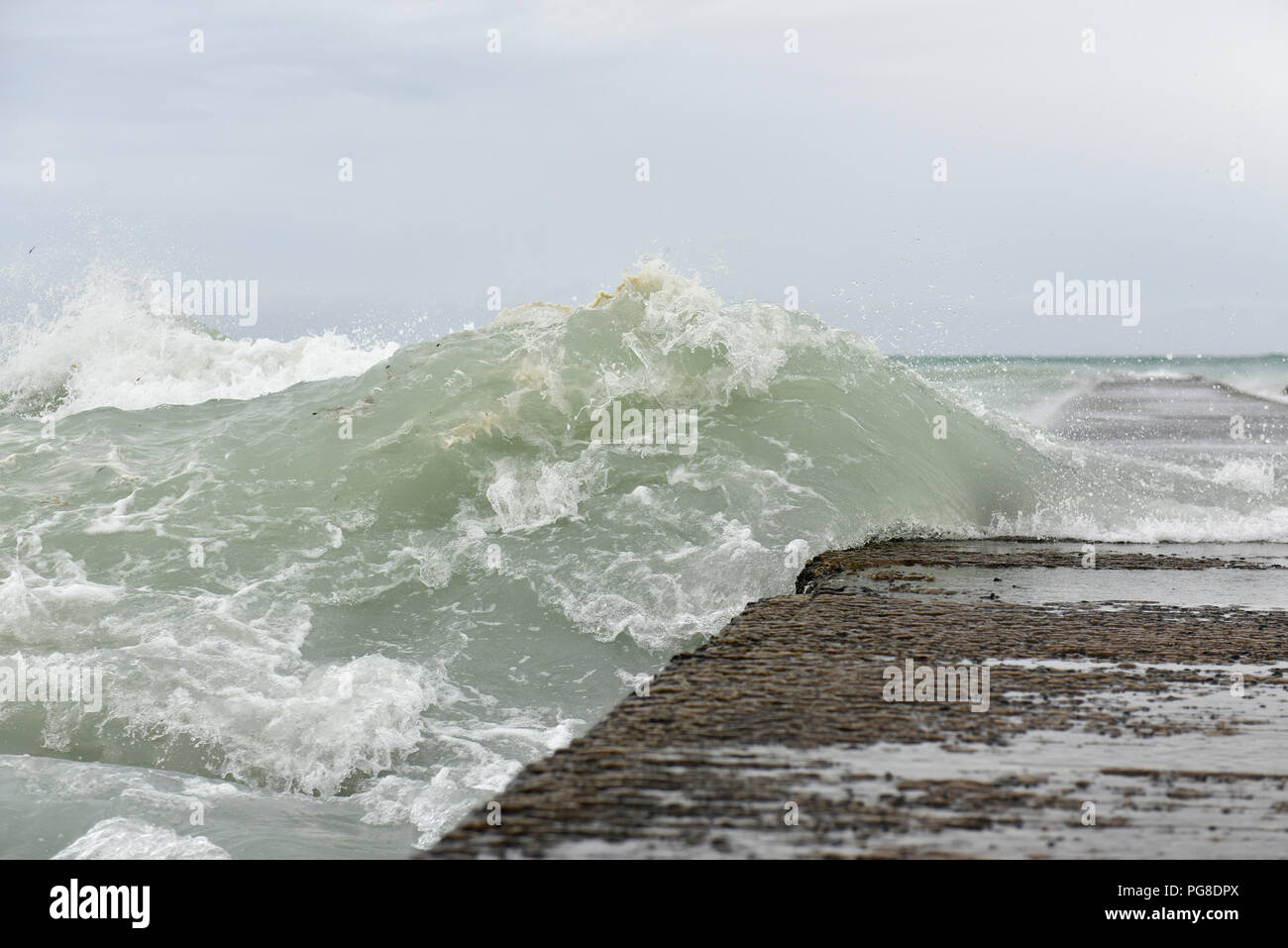 Honolulu. 23rd Aug, 2018. Photo taken on Aug. 23, 2018 shows strong tides lapping the seawall at Waikiki beach in Honolulu of Hawaii, the United States. Hurricane Lane, predicted as the biggest weather threat to Hawaii in decades, moved perilously close to the Aloha State Thursday morning, triggering heavy rain, landslide and flooding. Credit: Sun Ruibo/Xinhua/Alamy Live News Stock Photo