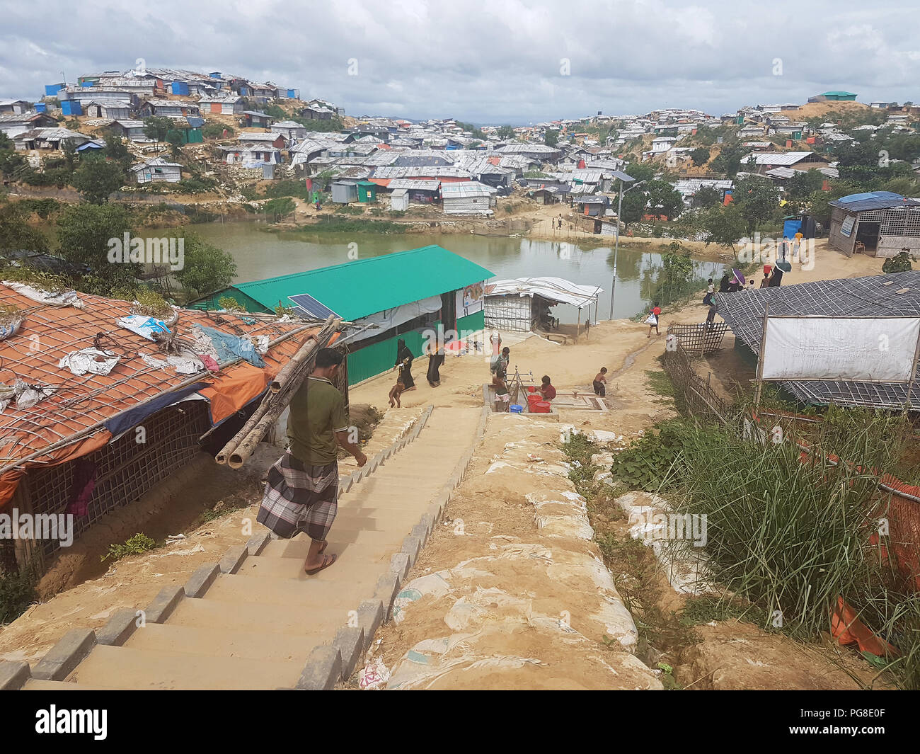 13 August 2018, Bangladesh, Cox's Bazar: In a Rohingya refugee camp large puddles have formed due to monsoon rain. Photo: Nick Kaiser/dpa Stock Photo