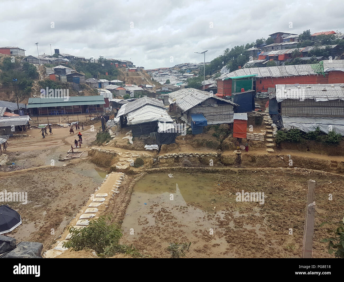 13 August 2018, Bangladesh, Cox's Bazar: In a Rohingya refugee camp large puddles have formed due to monsoon rain. Photo: Nick Kaiser/dpa Stock Photo
