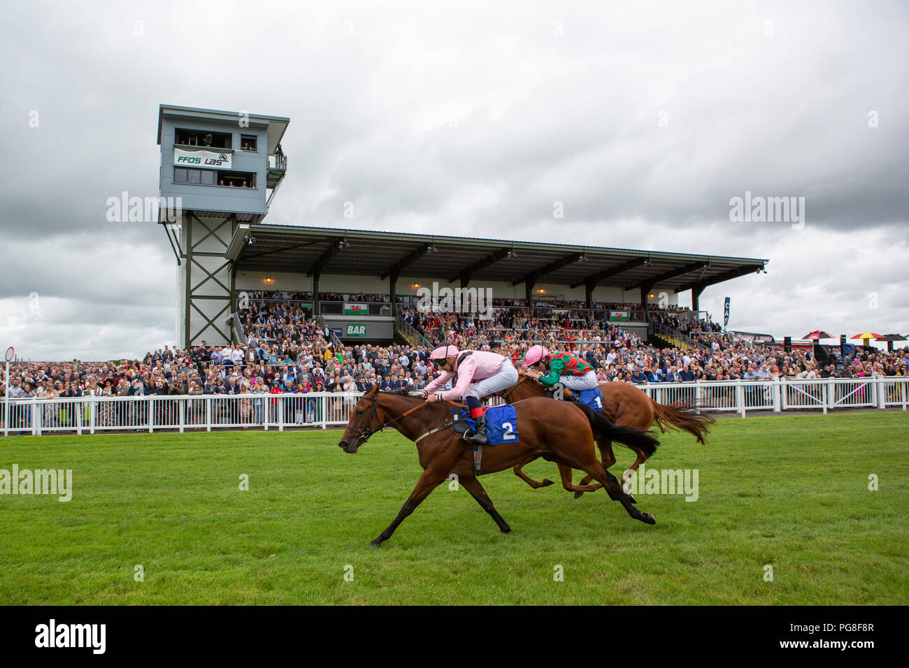 Ffos Las Racecourse, Trimsaran, Wales, UK. Friday 24 August 2018. One Kiss (jockey Gabriele Malune) wins the CP Hire Nursery Handicap (Race 1) from Improvising (jockey Finley Marsh) Credit: Gruffydd Thomas/Alamy Live News Stock Photo