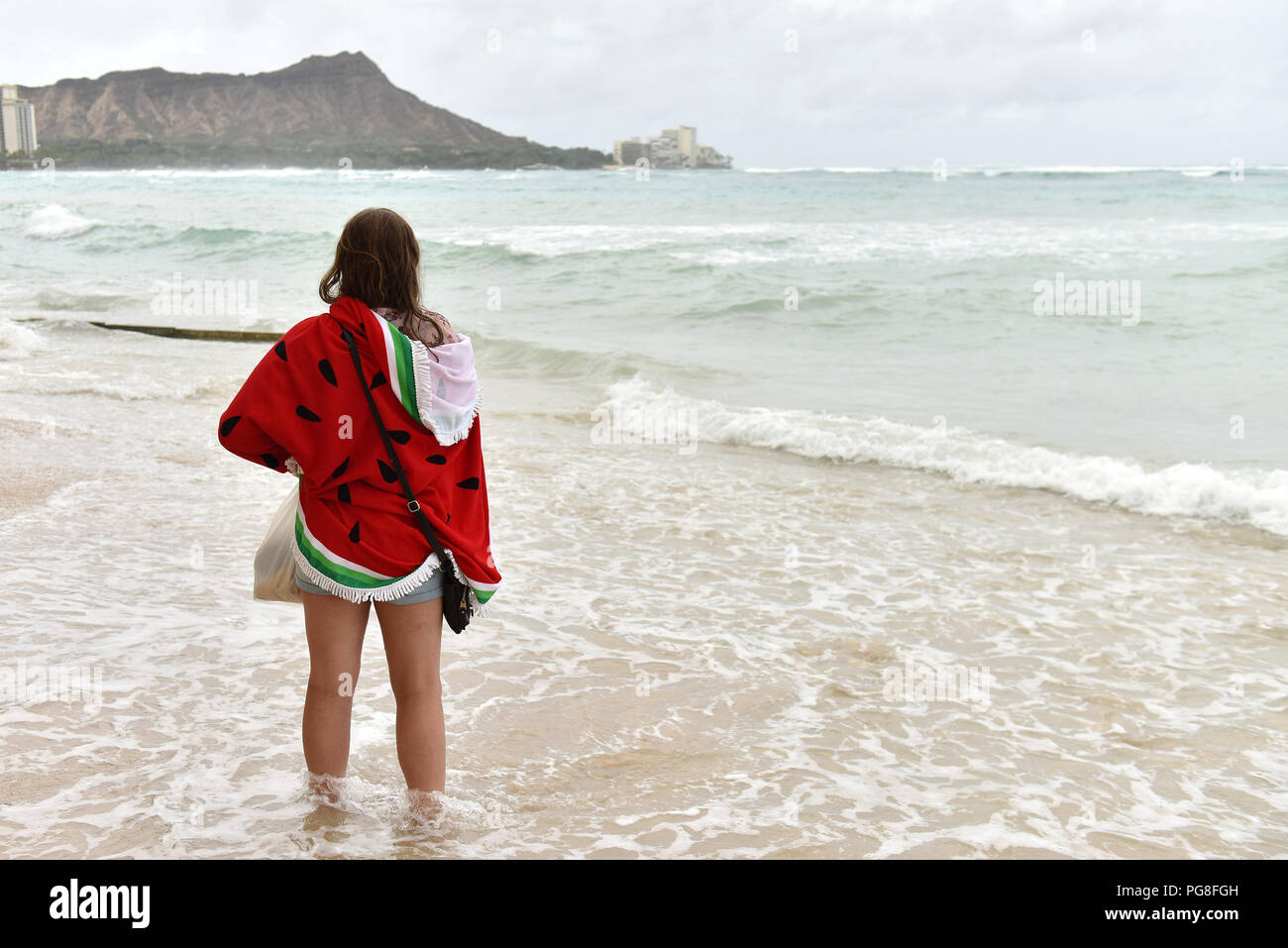 (180824) -- HONOLULU, Aug. 24, 2018 (Xinhua) -- A woman watches the tides at Waikiki beach in Honolulu of Hawaii, the United States, Aug. 23, 2018. Hurricane Lane, predicted as the biggest weather threat to Hawaii in decades, moved perilously close to the Aloha State Thursday morning, triggering heavy rain, landslide and flooding. (Xinhua/Sun Ruibo) (dtf) Stock Photo