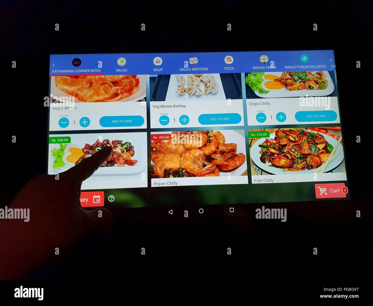 Kathmandu, Nepal. 24th Aug, 2018. A customer surfs the digital menu for his order at Naulo Restaurant, an automated restaurant in Kathmandu, Nepal, Aug. 24, 2018. Credit: Sunil Sharma/Xinhua/Alamy Live News Stock Photo