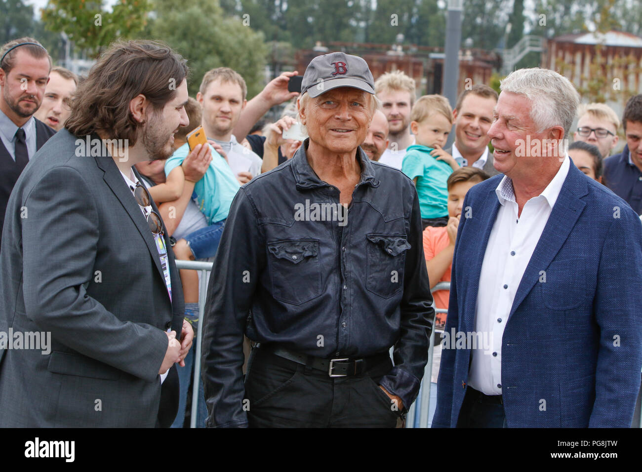 Worms, Germany. 24th August 2018. Actor Peter Englert, who initiated the renaming of the bridge to Terence-Hill-Bridge, Terence Hill and the Lord Mayor of Worms Michael Kissel are pictured from left to right. Italian actor Terence Hill visited the German city of Worms, to present his new movie (My Name is somebody). Terence Hill added the stop in Worms to his movie promotion tour in Germany, to visit a pedestrian bridge, that is unofficially named Terence-Hill-Bridge (officially Karl-Kubel-Bridge). Stock Photo