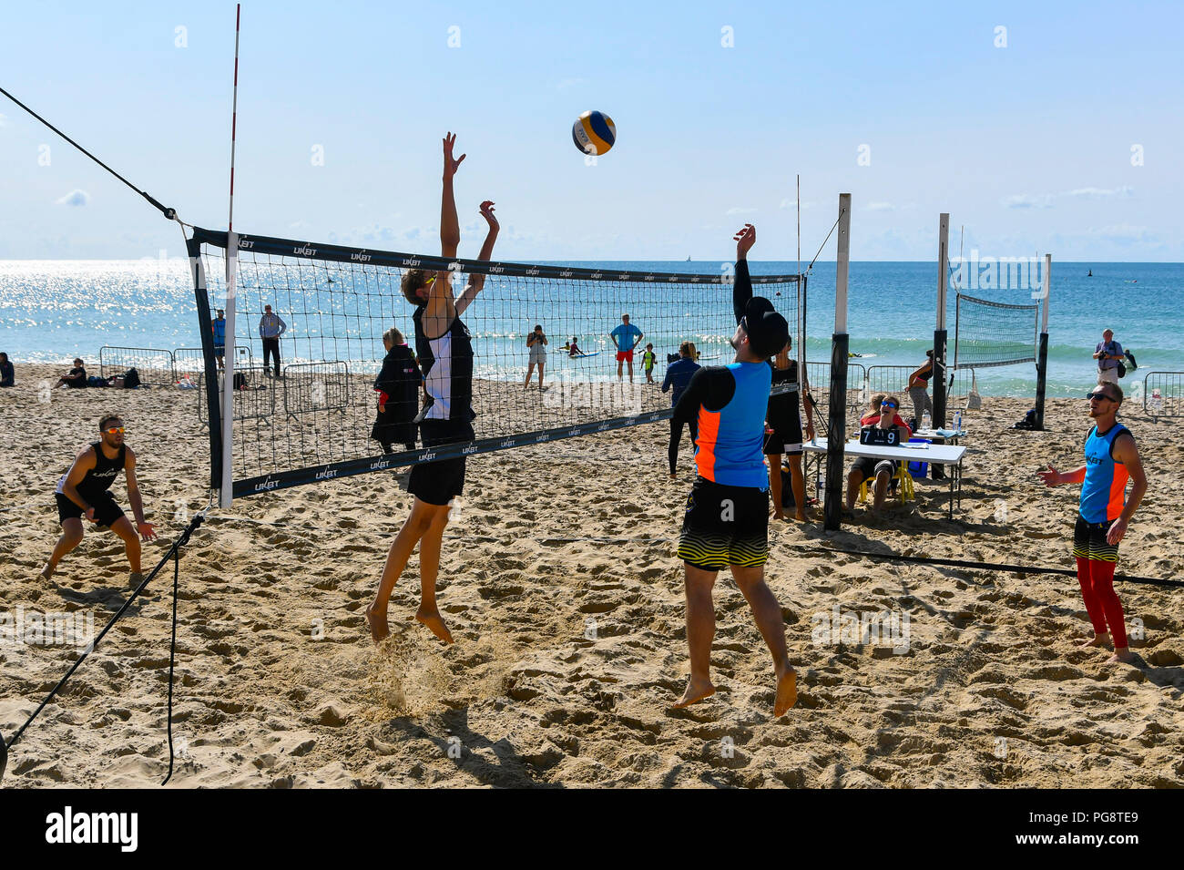 Boscombe, Bournemouth, Dorset, UK.  25th August 2018. UK Weather.  Beach Volleyball players competing in the UK Beach Tour enjoying a morning of warm sunshine and blue skies on the beach at Boscombe near Bournemouth in Dorset.  Picture Credit: Graham Hunt/Alamy Live News Stock Photo