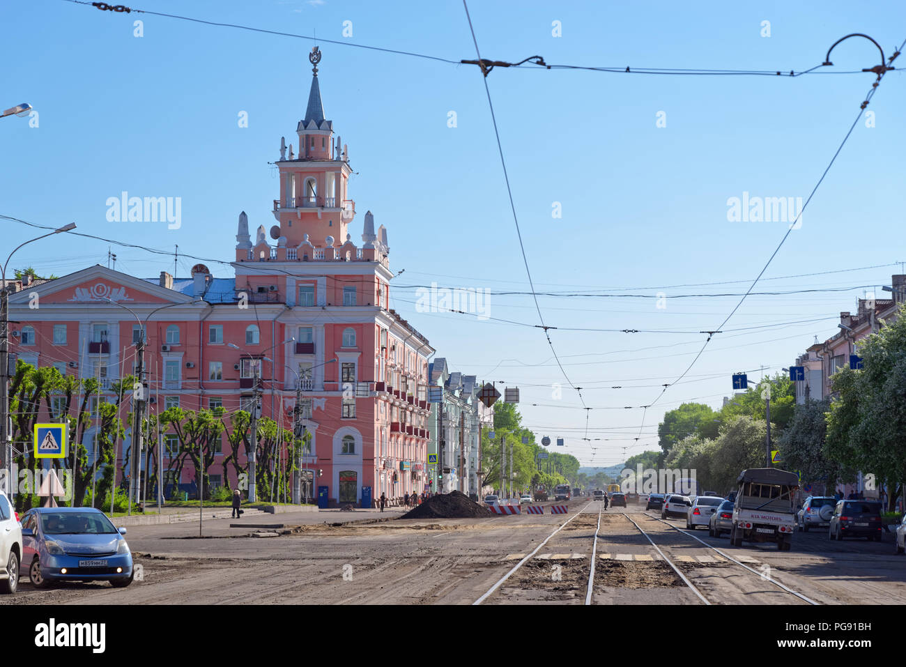 Komsomolsk-on-Amur, Russia - May 26, 2018: View on the pink house with a spire (unofficial city symbol) from the street called 'Prospekt Lenina'. Stock Photo