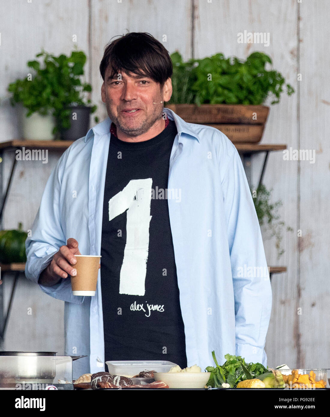 Organiser Alex James on the NEF Big Kitchen stage during the Big Feastival  at James' farm in Kingham, Oxfordshire Stock Photo - Alamy