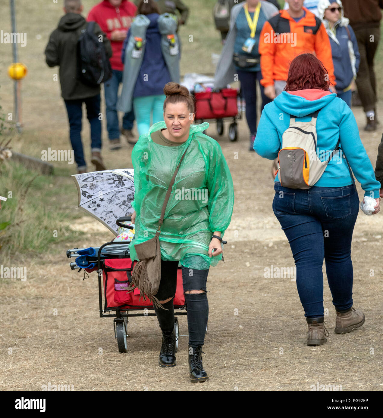 Festival goers face a rain shower during the Big Feastival at Alex
