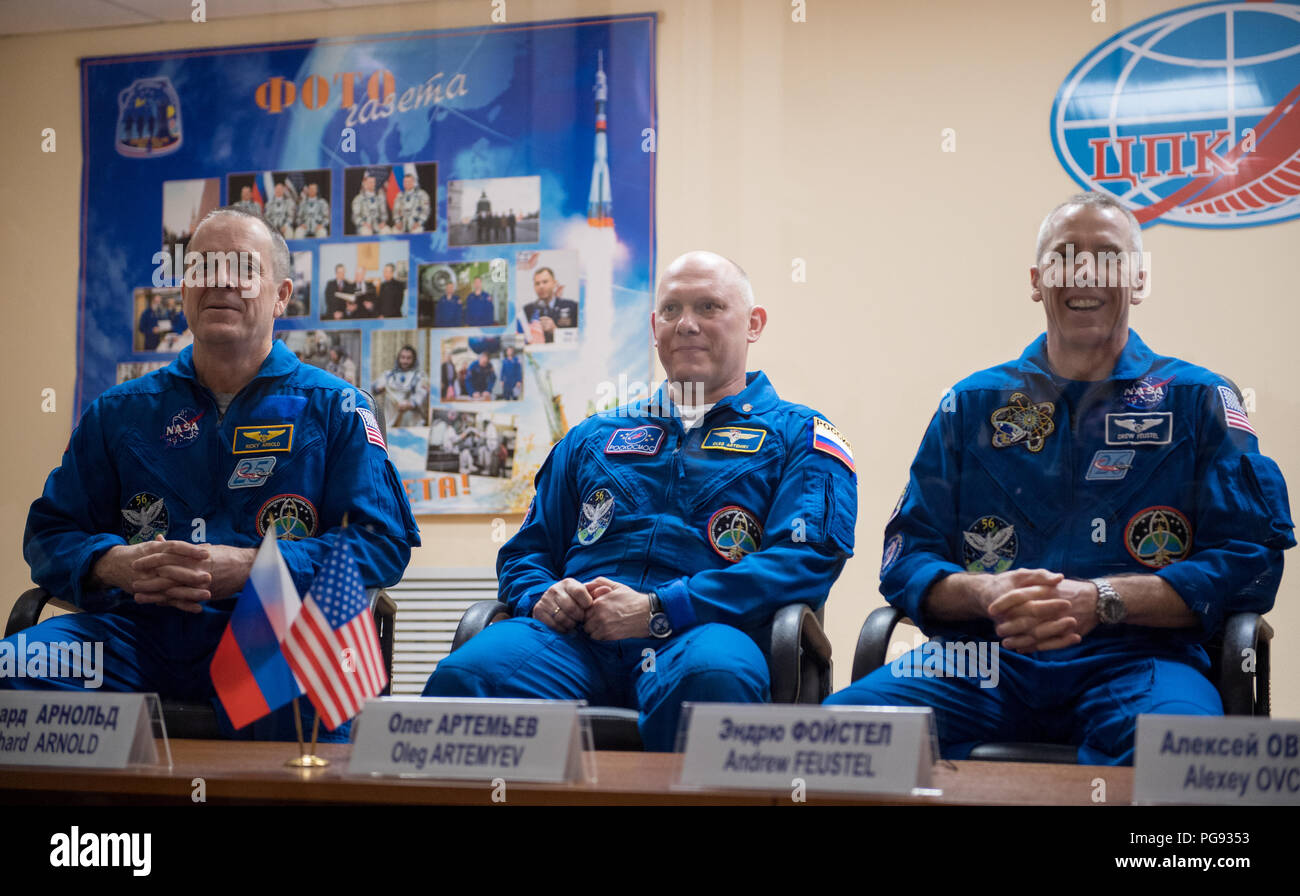 Expedition 55 flight engineer Ricky Arnold of NASA, left, Soyuz Commander Oleg Artemyev of Roscosmos, center, and flight engineer Drew Feustel of NASA, right, are seen in quarantine, behind glass, during a press conference, Tuesday, March 20, 2018 at the Cosmonaut Hotel in Baikonur, Kazakhstan. Arnold, Artemyev, and Feustel are scheduled to launch to the International Space Station aboard the Soyuz MS-08 spacecraft on Wednesday, March, 21. Stock Photo