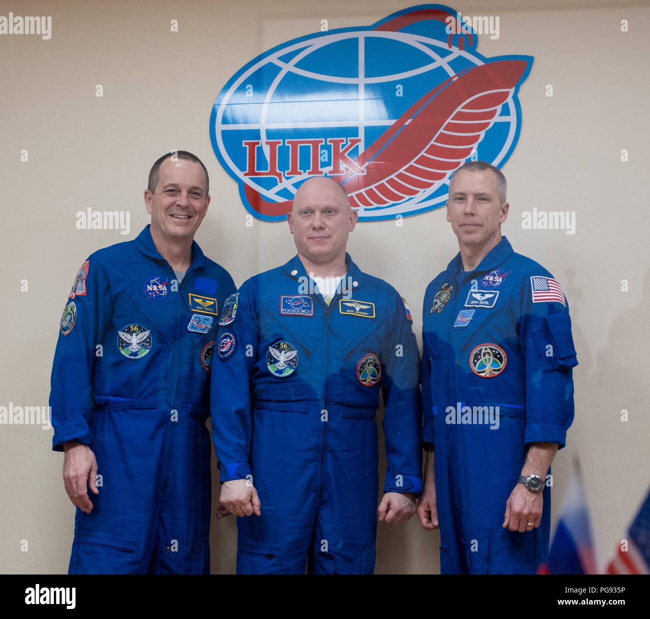 Expedition 55 flight engineer Ricky Arnold of NASA, left, Soyuz Commander Oleg Artemyev of Roscosmos, center, and flight engineer Drew Feustel of NASA, right, pose for a picture at the conclusion of a press conference, Tuesday, March 20, 2018 at the Cosmonaut Hotel in Baikonur, Kazakhstan. Arnold, Artemyev, and Feustel are scheduled to launch to the International Space Station aboard the Soyuz MS-08 spacecraft on Wednesday, March, 21. Stock Photo