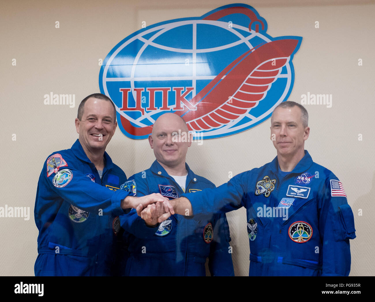 Expedition 55 flight engineer Ricky Arnold of NASA, left, Soyuz Commander Oleg Artemyev of Roscosmos, center, and flight engineer Drew Feustel of NASA, right, pose for a picture at the conclusion of a press conference, Tuesday, March 20, 2018 at the Cosmonaut Hotel in Baikonur, Kazakhstan. Arnold, Artemyev, and Feustel are scheduled to launch to the International Space Station aboard the Soyuz MS-08 spacecraft on Wednesday, March, 21. Stock Photo