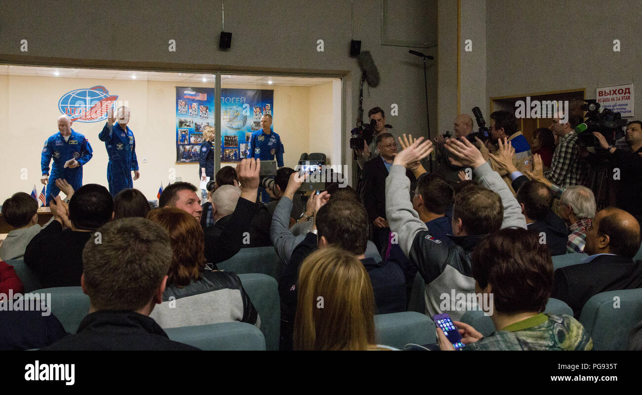 Expedition 55 flight engineer Ricky Arnold of NASA, left, Soyuz Commander Oleg Artemyev of Roscosmos, center, and flight engineer Drew Feustel of NASA, right, are seen at the conclusion of a press conference, Tuesday, March 20, 2018 at the Cosmonaut Hotel in Baikonur, Kazakhstan. Arnold, Artemyev, and Feustel are scheduled to launch to the International Space Station aboard the Soyuz MS-08 spacecraft on Wednesday, March, 21. Stock Photo