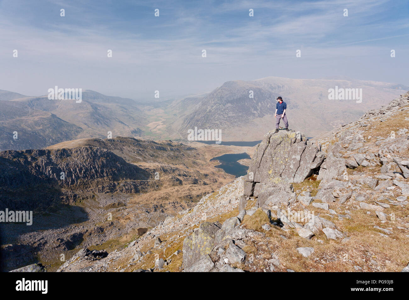 Man on a rock high on the Gylderau mountains, Snowdonia, North Wales Stock Photo