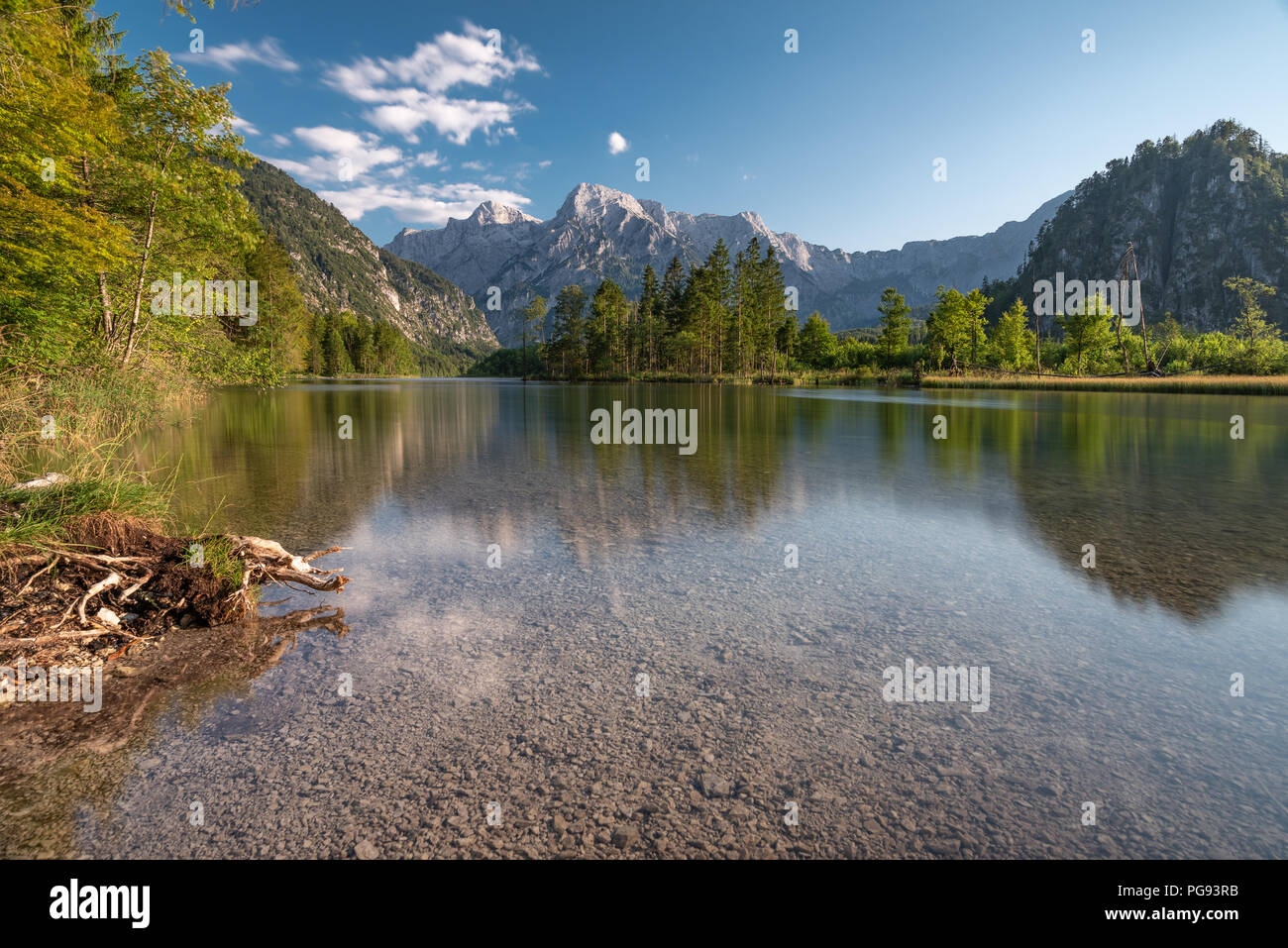 Beautiful Amlsee in  Upper Austria at the end of a hot summer 2018. Clear water and reflecting mountains are the basic for a perfect nature made comp. Stock Photo