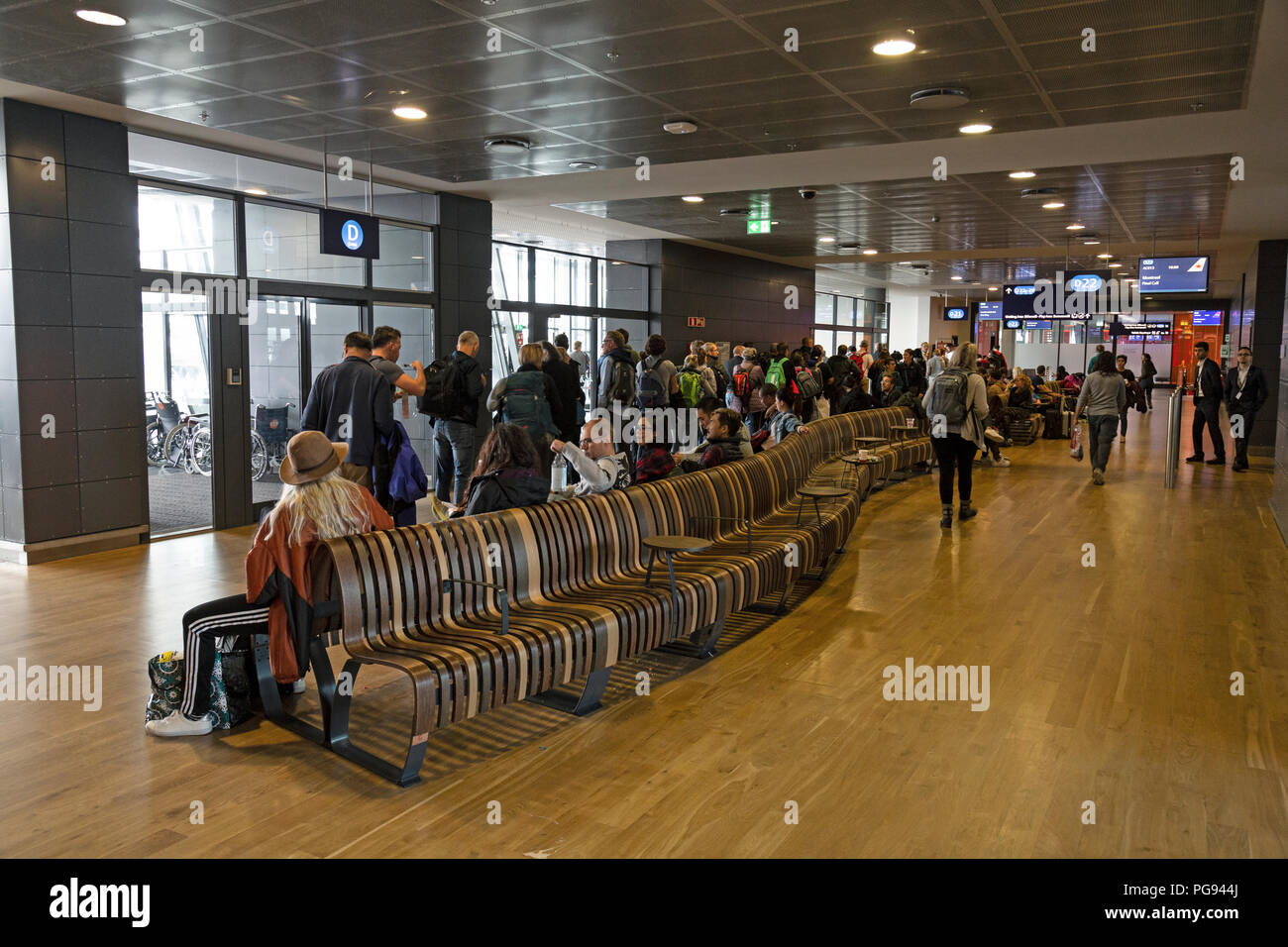 Passengers awaiting to board their flight at Reykjavik Keflavik airport in Iceland. Stock Photo