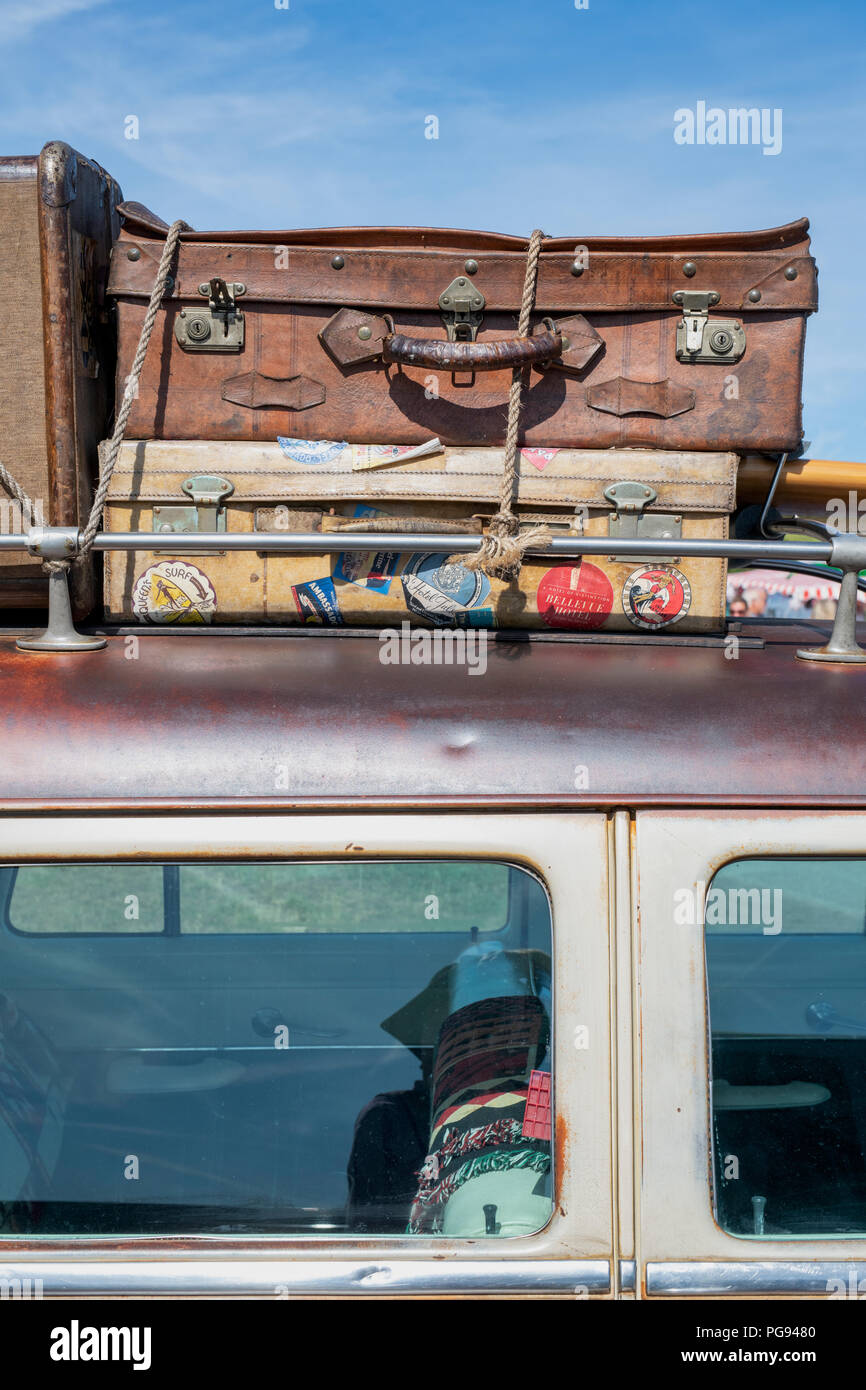 Old suitcases on a 1954 Ford Country Squire station wagon at a vintage retro festival. UK Stock Photo