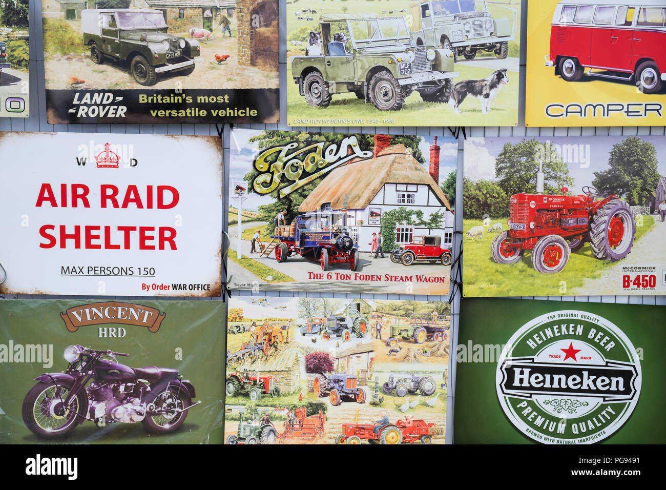 Reproduction retro tin signs for sale on a stall at a vintage retro festival. UK Stock Photo