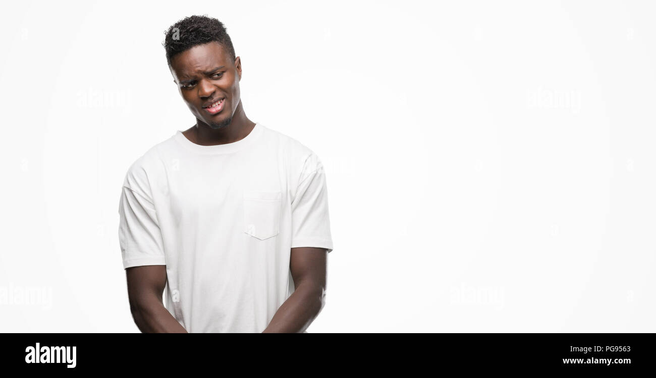 Young african american man wearing white t-shirt looking away to side ...