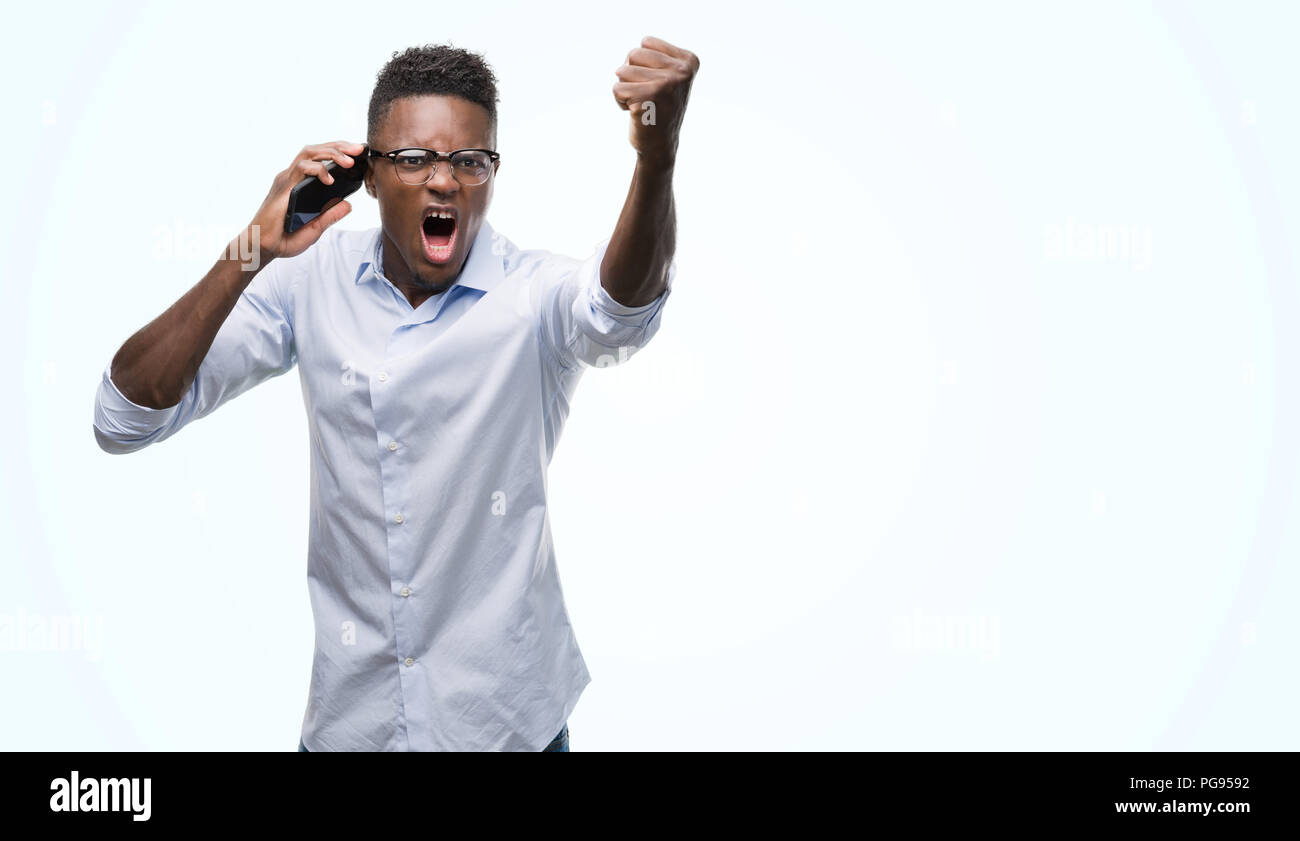 Shouting With Rage Young african american man using smartphone annoyed and frustrated ...