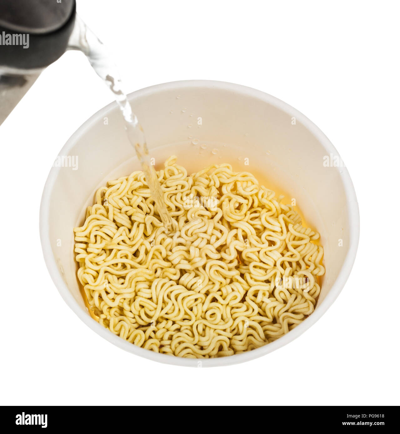 cooking instant noodles pouring water from kettle into box with dried