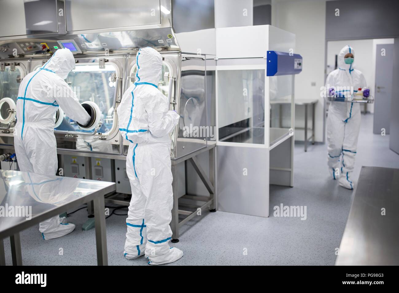 Technicians working in sealed, sterile isolator units in a laboratory that manufactures human tissues for implant. Such tissues include bone and skin grafts. Stock Photo