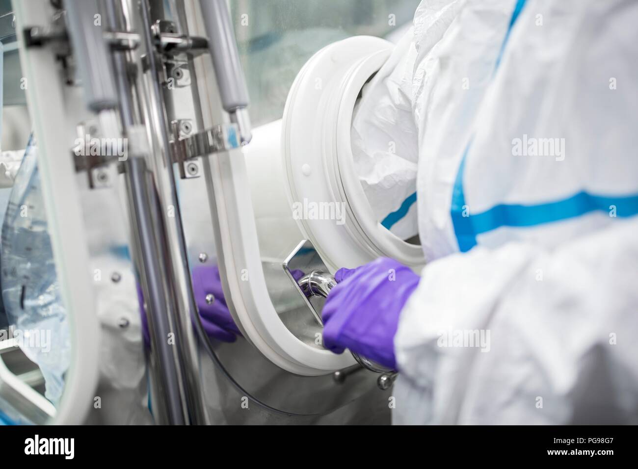Technicians working in sealed, sterile isolator units in a laboratory that manufactures human tissues for implant. Such tissues include bone and skin grafts. Stock Photo