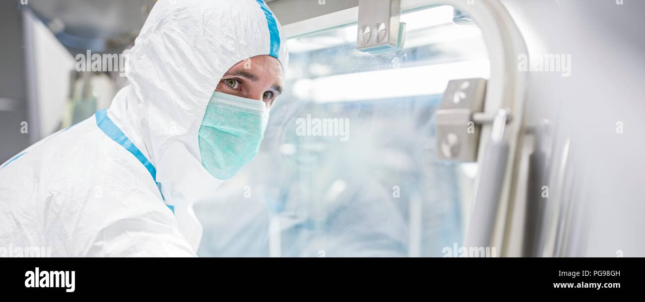 Technicians working in sealed, sterile isolator units in a laboratory that manufactures human tissues for implant. Such tissues include bone and skin grafts. Stock Photo