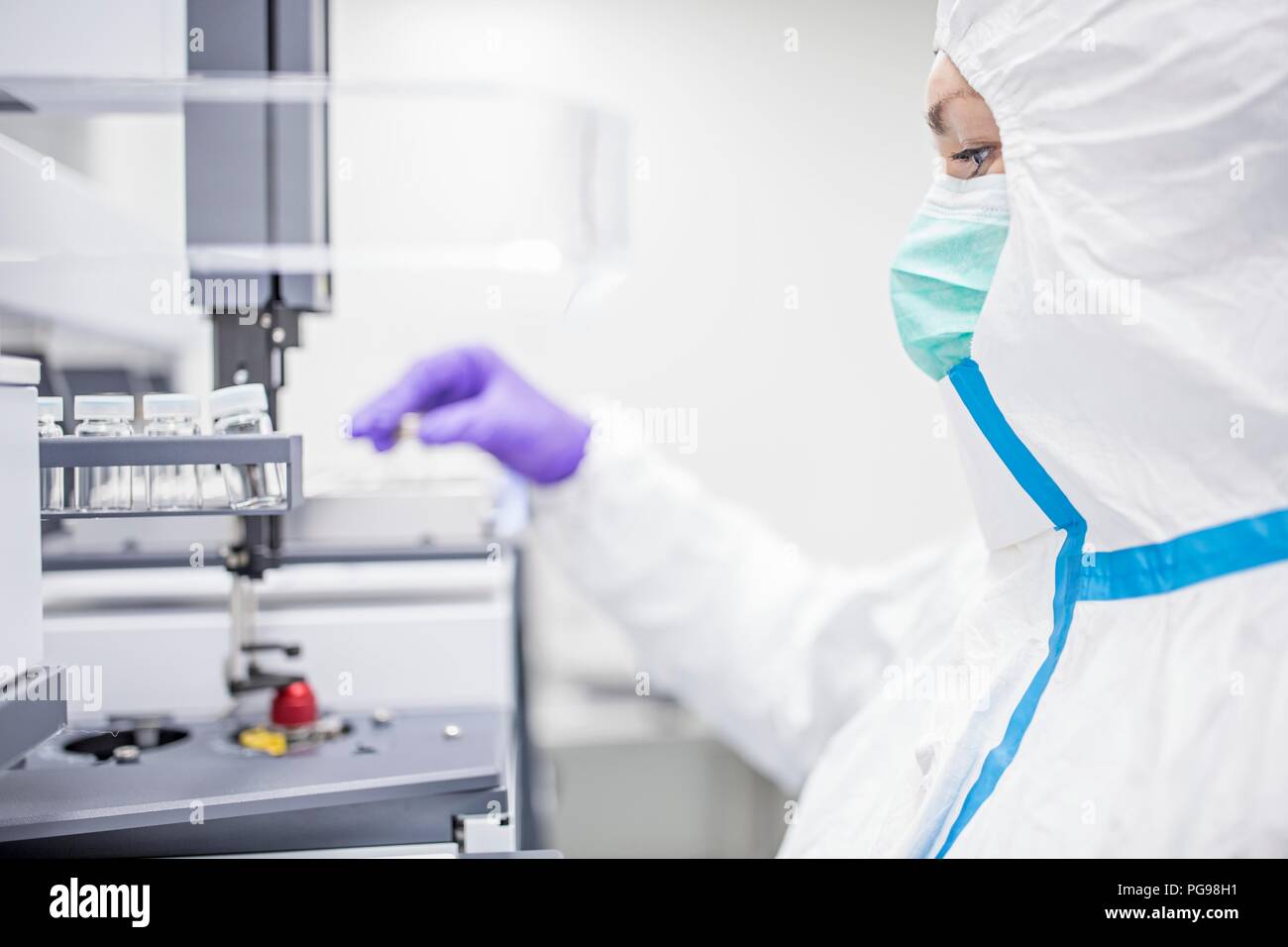 Technician checking stem cell cultures in a laboratory that manufactures human tissues for implants. Such implants include bone and skin grafts. Stock Photo