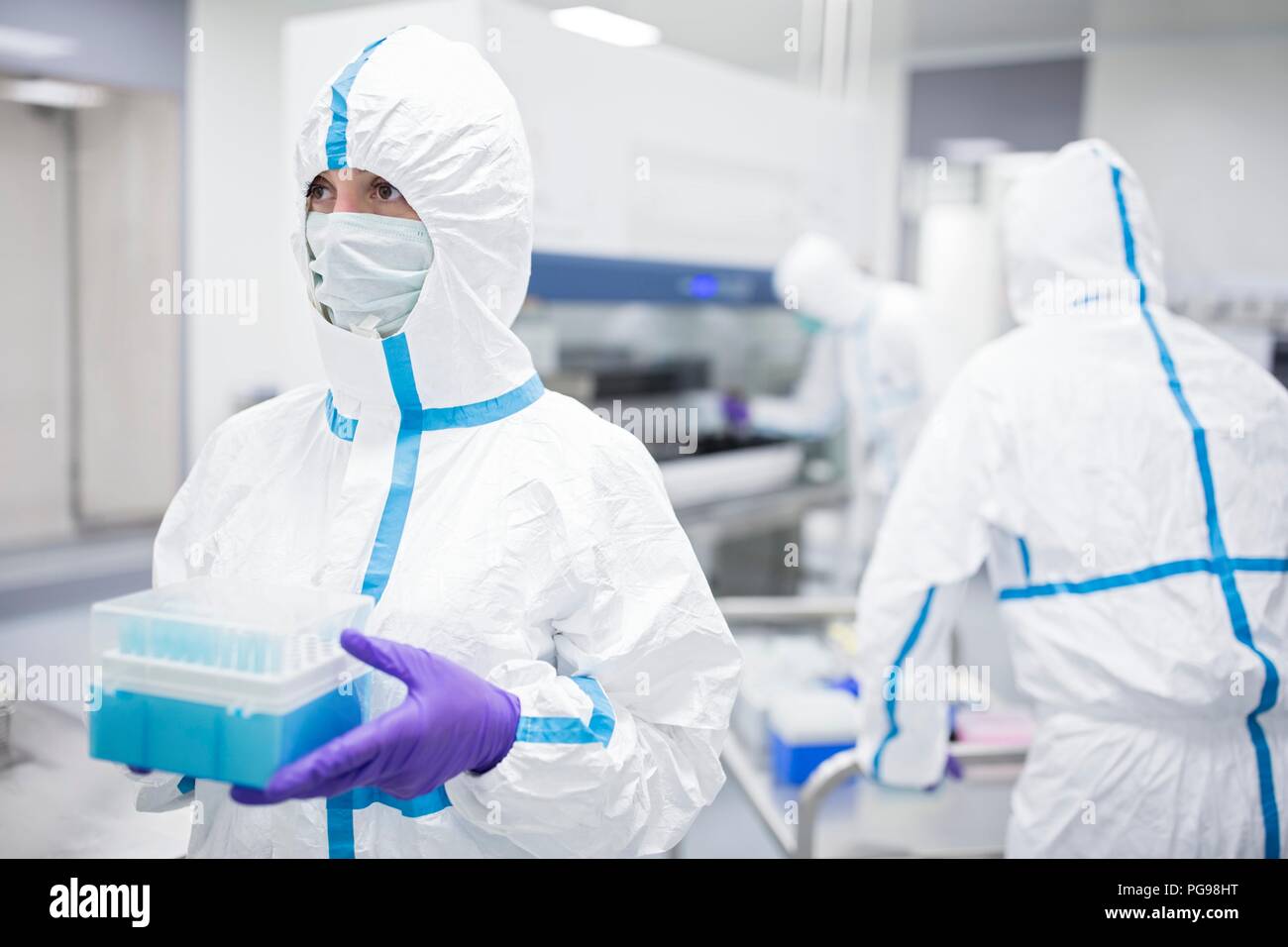 Technician holding cell samples in in a laboratory that engineers human tissues for implant. Such implants include bone and skin grafts. Stock Photo